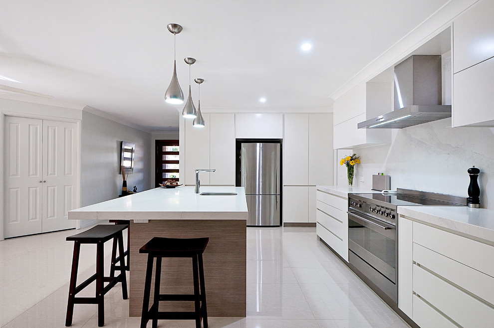 Design ideas for a contemporary l-shaped kitchen in Brisbane with an undermount sink, flat-panel cabinets, white cabinets, white splashback, stainless steel appliances and with island.