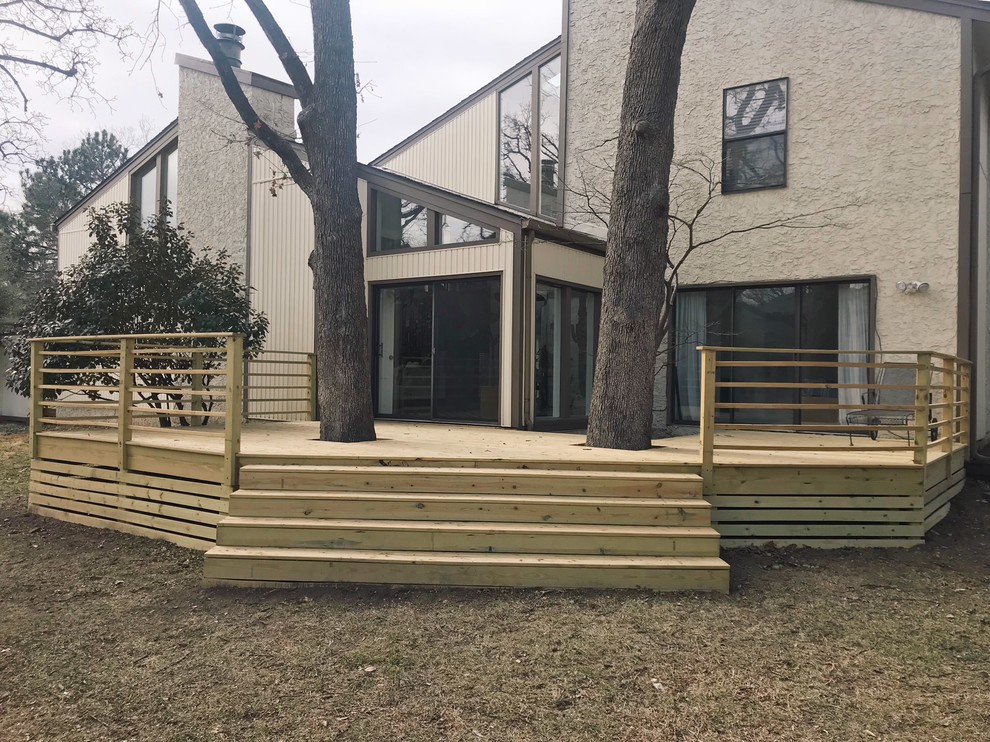 This is an example of a mid-sized contemporary side yard deck in Other with no cover.