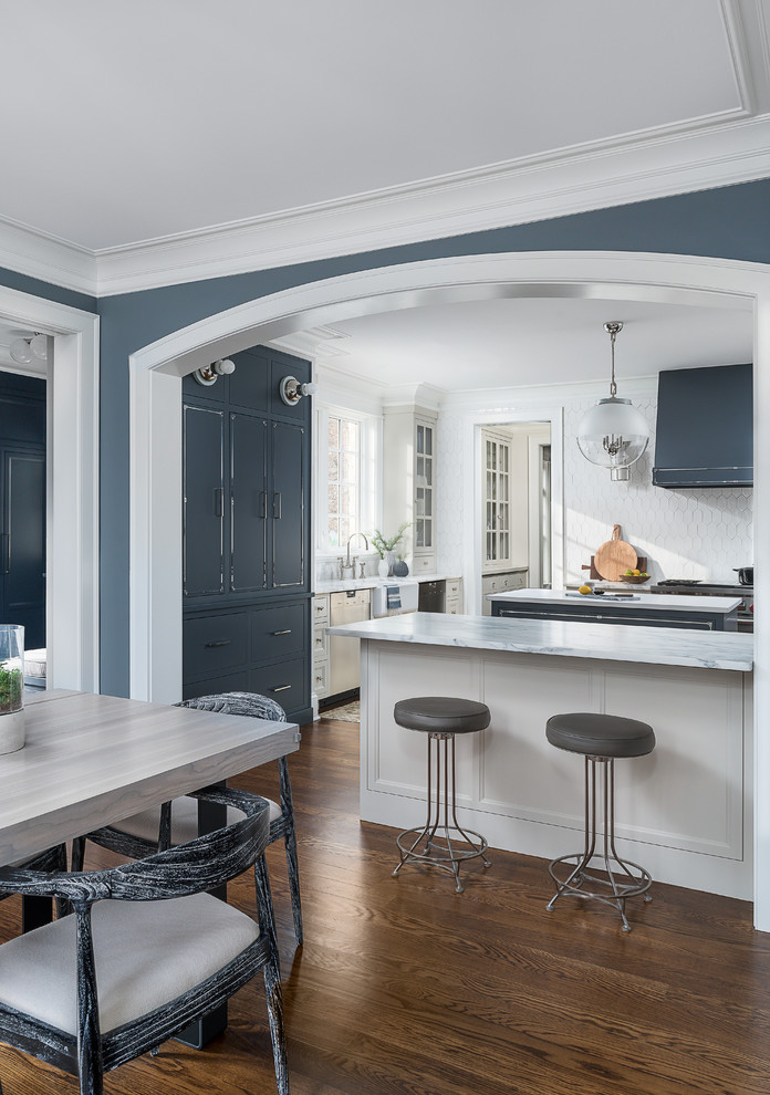 Kitchen - large transitional medium tone wood floor and brown floor kitchen idea in Chicago with a farmhouse sink, beaded inset cabinets, blue cabinets, marble countertops, white backsplash, ceramic backsplash, stainless steel appliances, two islands and yellow countertops