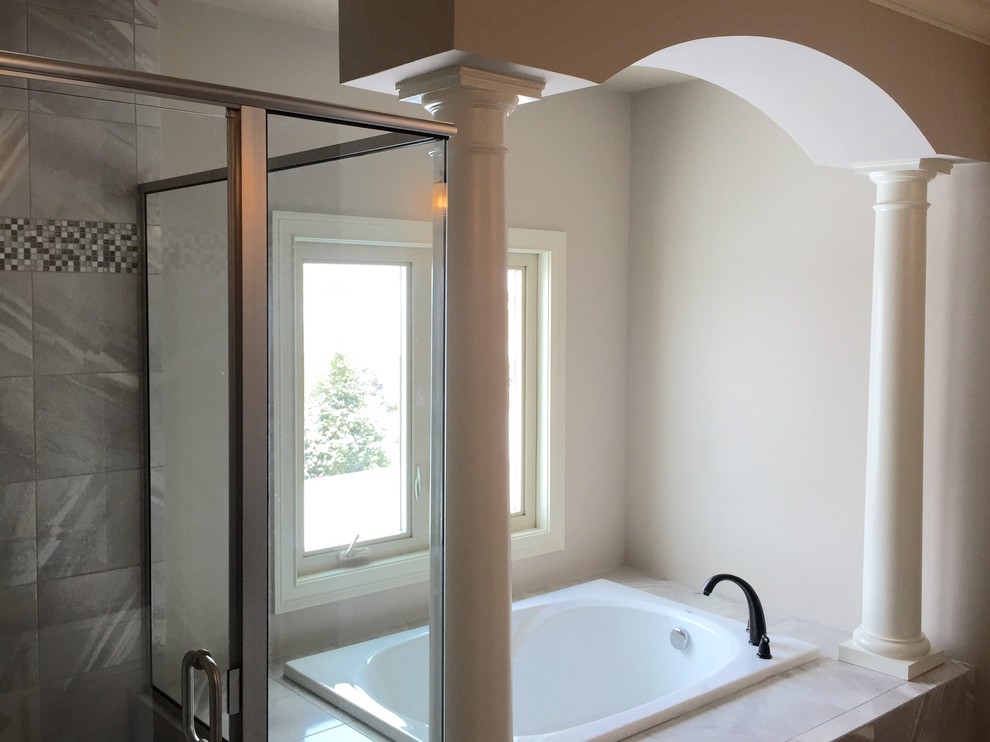 Inspiration for a large transitional master drop-in bathtub remodel in Cincinnati with beige walls