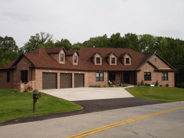 Example of a large brown one-story brick exterior home design