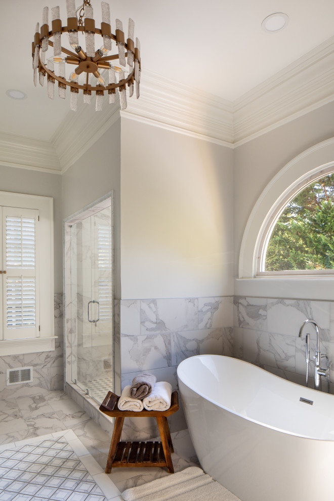 Freestanding bathtub - large transitional master white tile and marble tile ceramic tile, white floor and double-sink freestanding bathtub idea in Atlanta with raised-panel cabinets, white cabinets, a two-piece toilet, gray walls, an undermount sink, quartz countertops, a hinged shower door, white countertops and a built-in vanity