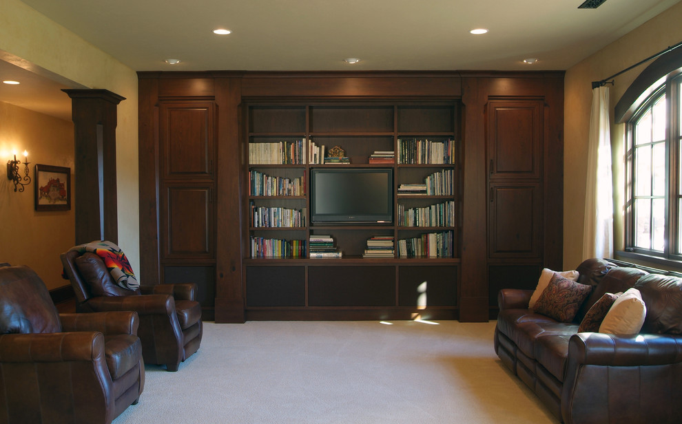 Inspiration for an expansive mediterranean enclosed family room in Grand Rapids with beige walls, carpet and a built-in media wall.