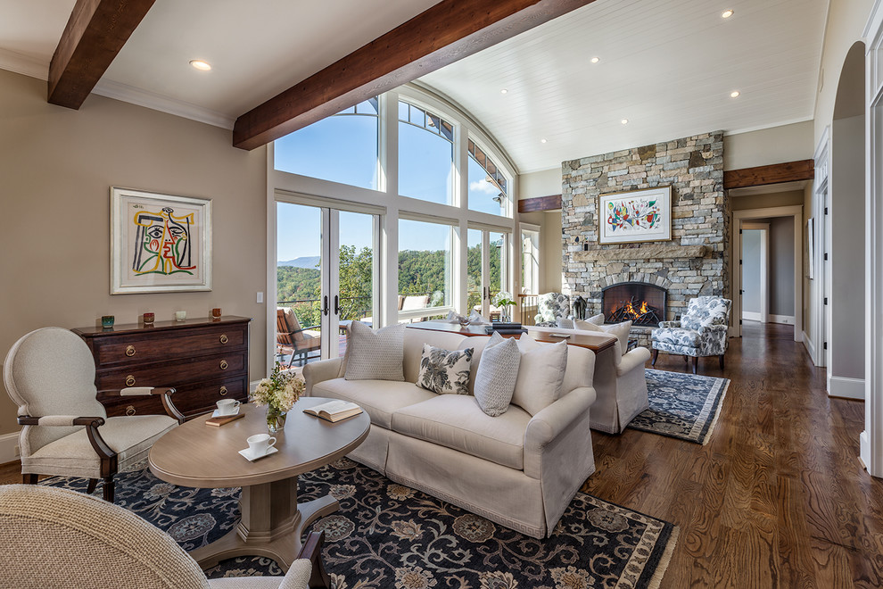 This is an example of a large transitional open concept living room in Other with beige walls, dark hardwood floors, a standard fireplace and a stone fireplace surround.