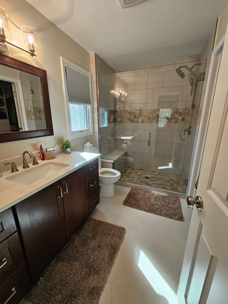 Alcove shower - mid-sized transitional master gray tile and porcelain tile porcelain tile, beige floor and single-sink alcove shower idea with shaker cabinets, dark wood cabinets, gray walls, an undermount sink, quartz countertops, a hinged shower door, white countertops and a freestanding vanity
