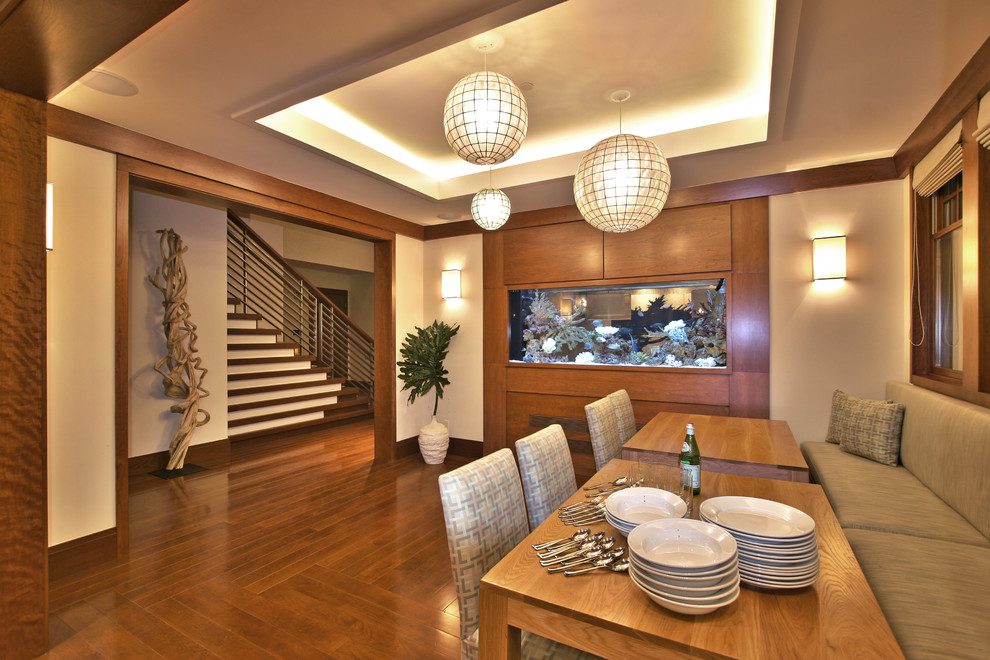 This is an example of a contemporary dining room in Los Angeles with beige walls and dark hardwood floors.