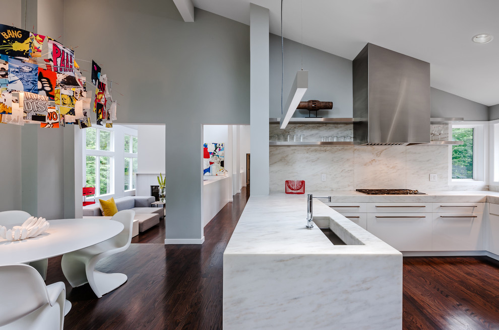 Inspiration for a modern u-shaped eat-in kitchen in Minneapolis with stainless steel appliances, flat-panel cabinets, white cabinets, white splashback and stone slab splashback.