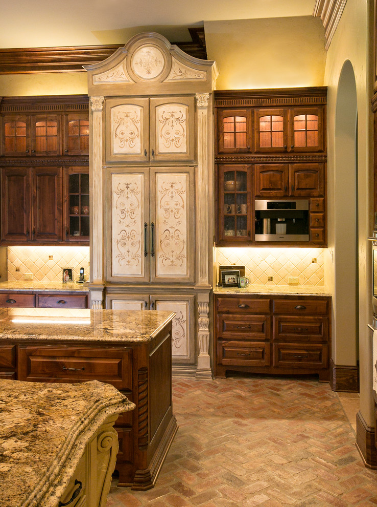 Photo of a mediterranean kitchen in New Orleans with brick floors.