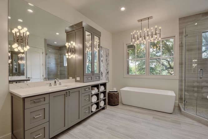 Large transitional master gray tile and porcelain tile porcelain tile and gray floor freestanding bathtub photo in Austin with shaker cabinets, gray cabinets, white walls, an undermount sink, quartzite countertops, a hinged shower door and white countertops