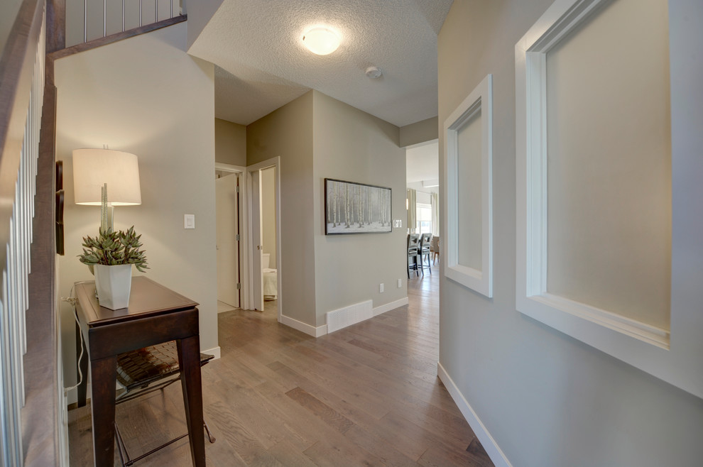 Mid-sized transitional light wood floor and brown floor foyer photo in Edmonton with gray walls and a gray front door