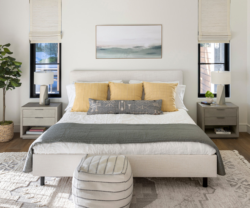 Design ideas for a country guest bedroom in San Francisco with white walls, medium hardwood floors and brown floor.
