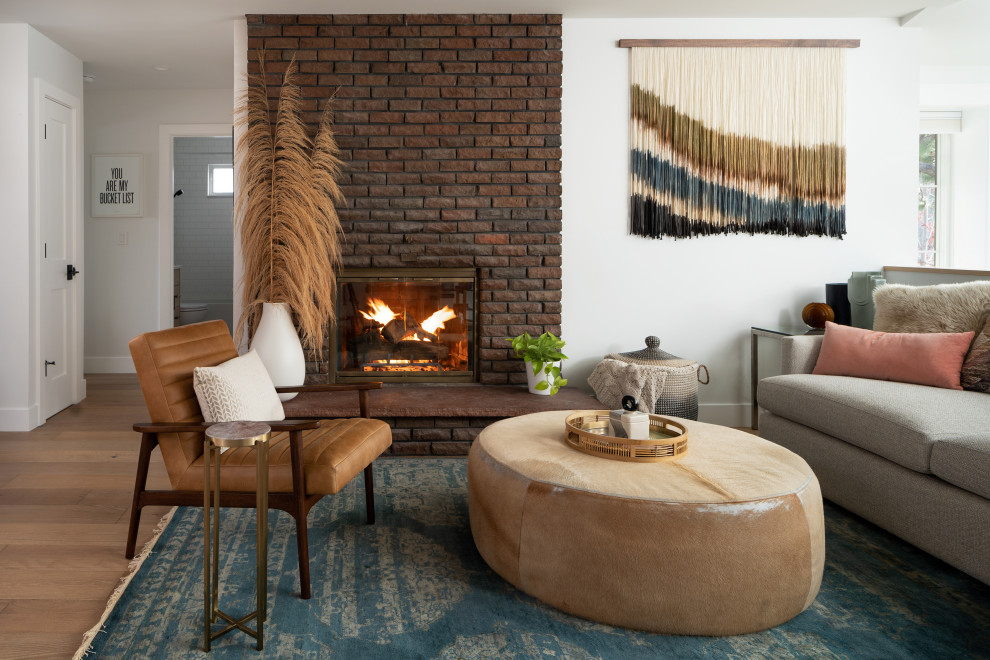 Inspiration for a contemporary open concept and formal light wood floor and brown floor living room remodel in Denver with white walls, a wood stove, a brick fireplace and no tv