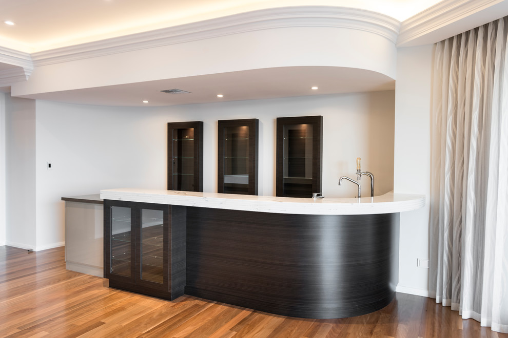 Inspiration for an expansive contemporary single-wall seated home bar in Perth with an undermount sink, grey cabinets, quartz benchtops, medium hardwood floors and brown floor.