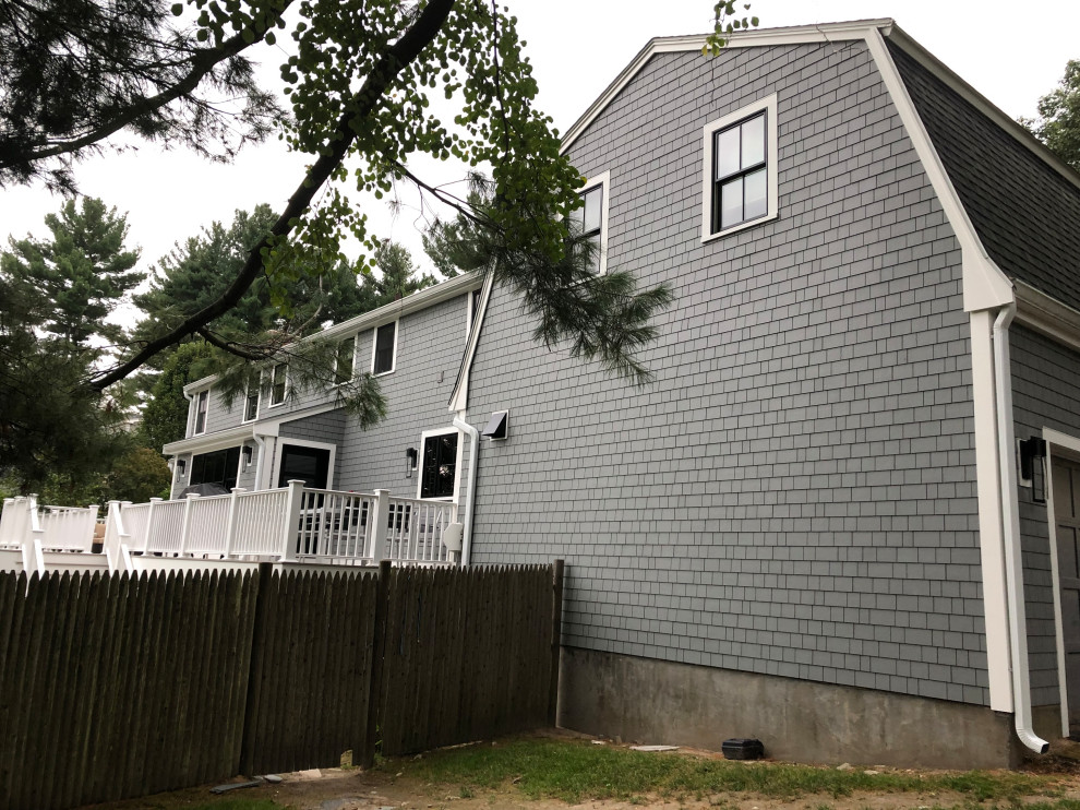 Photo of a large arts and crafts two-storey grey house exterior in Boston with mixed siding, a gable roof and a shingle roof.