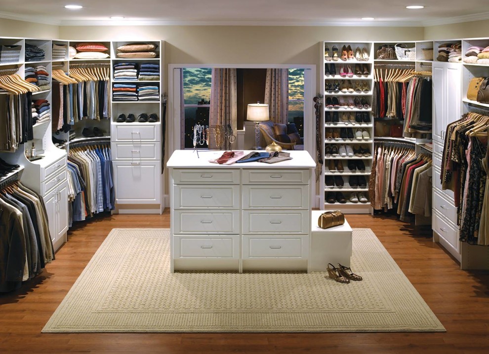 Photo of a large traditional gender-neutral dressing room in Other with raised-panel cabinets, white cabinets, medium hardwood floors and brown floor.