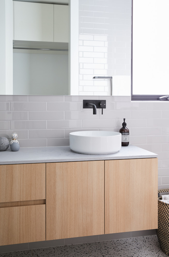 Inspiration for a small scandinavian bathroom in Melbourne with light wood cabinets, a freestanding tub, an open shower, gray tile, subway tile, grey walls, terrazzo floors, concrete benchtops, grey floor, an open shower and grey benchtops.