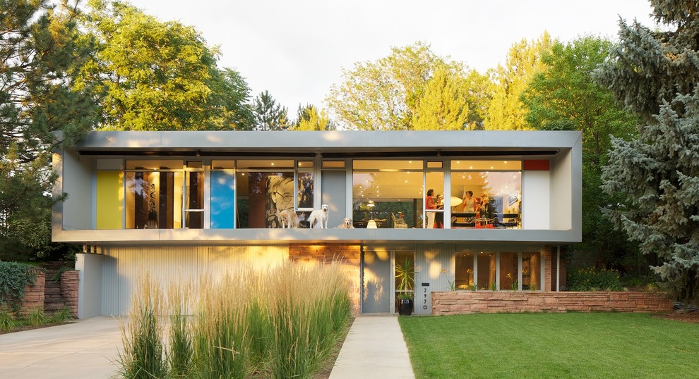 Inspiration for a midcentury two-storey grey exterior in Denver with a flat roof.