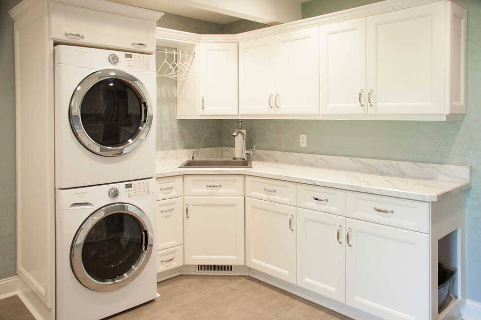 Design ideas for a contemporary laundry room in Chicago with an undermount sink, recessed-panel cabinets, white cabinets, marble benchtops, green walls, plywood floors and a stacked washer and dryer.
