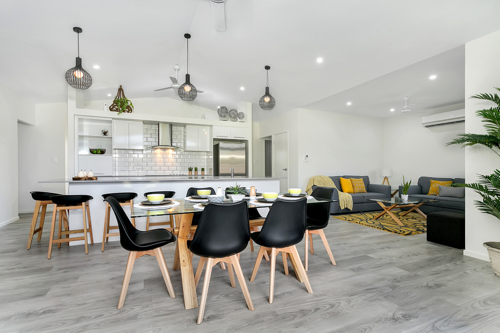 Inspiration for a mid-sized contemporary open plan dining in Cairns with white walls, painted wood floors and grey floor.