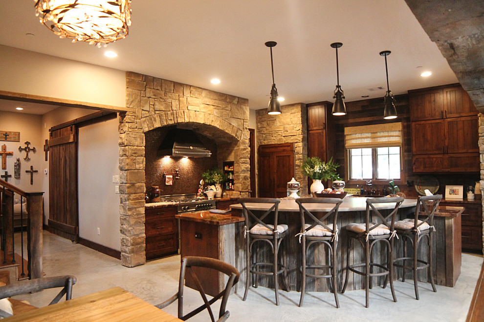 This is an example of a large country l-shaped open plan kitchen in Houston with an undermount sink, shaker cabinets, distressed cabinets, marble benchtops, brown splashback, mosaic tile splashback, stainless steel appliances, concrete floors and with island.