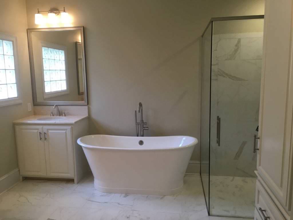 Renovated master bath was gutted to maximize the floor space and add function to the space.The original corner jacuzz tub was removed and a new vanity was designed in its place. A new floor mounted fa