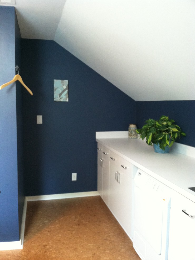 Photo of a mid-sized transitional utility room in Richmond with a single-bowl sink, white cabinets, laminate benchtops, blue walls, cork floors and a side-by-side washer and dryer.