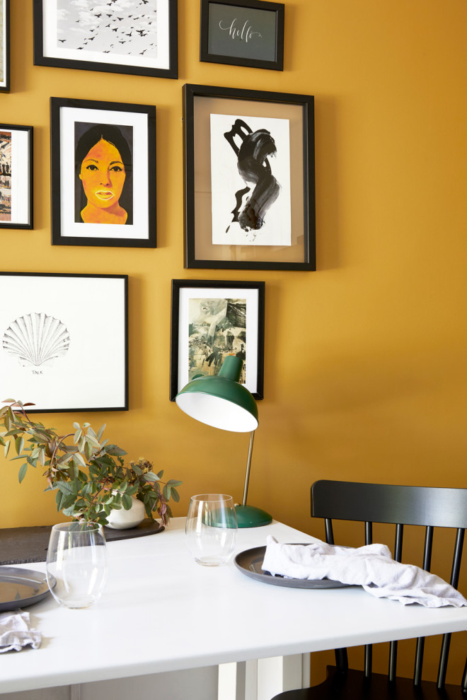 Small contemporary open plan dining in London with yellow walls.