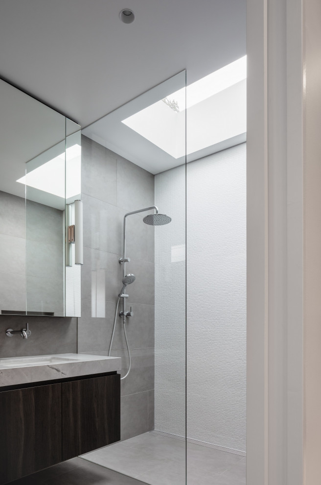 Photo of a large contemporary bathroom in Sydney with an undermount sink, granite benchtops, an open shower, a double vanity, dark wood cabinets, flat-panel cabinets, an alcove shower, gray tile, grey floor, grey benchtops and a floating vanity.