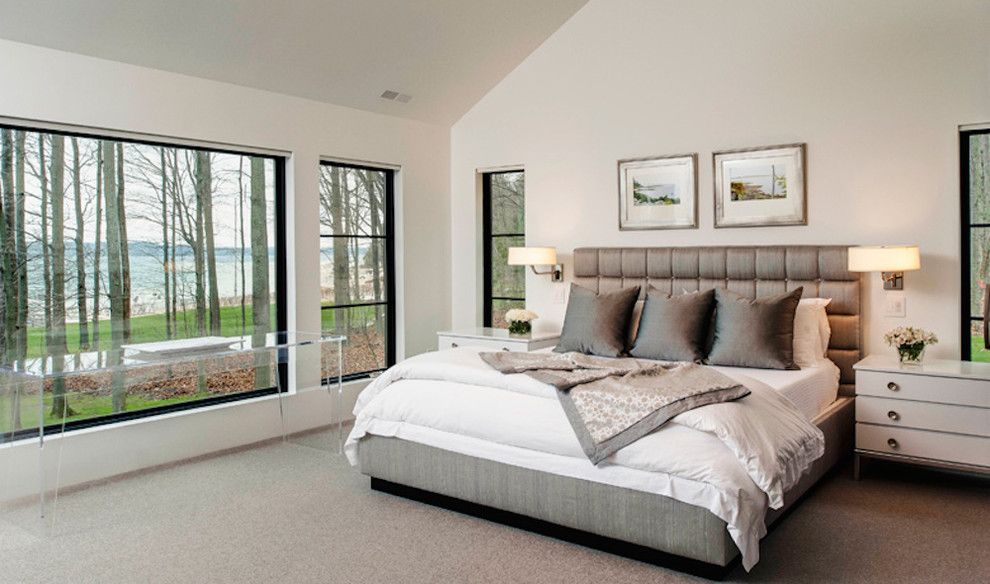 Photo of a large contemporary master bedroom in Other with white walls, carpet, no fireplace and beige floor.