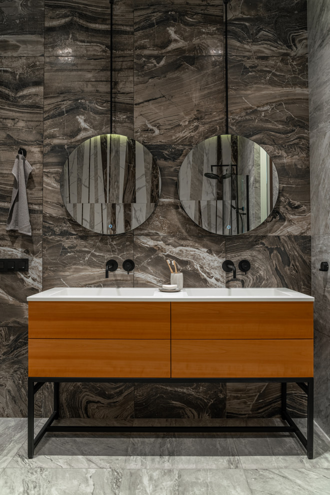 Photo of a medium sized scandinavian cloakroom in Saint Petersburg with flat-panel cabinets, medium wood cabinets, beige tiles, marble tiles, beige walls, wood-effect flooring, a submerged sink, tiled worktops, beige floors, white worktops and a floating vanity unit.