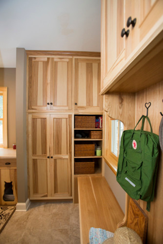 Example of a mid-sized mountain style porcelain tile mudroom design in Minneapolis with gray walls and a medium wood front door