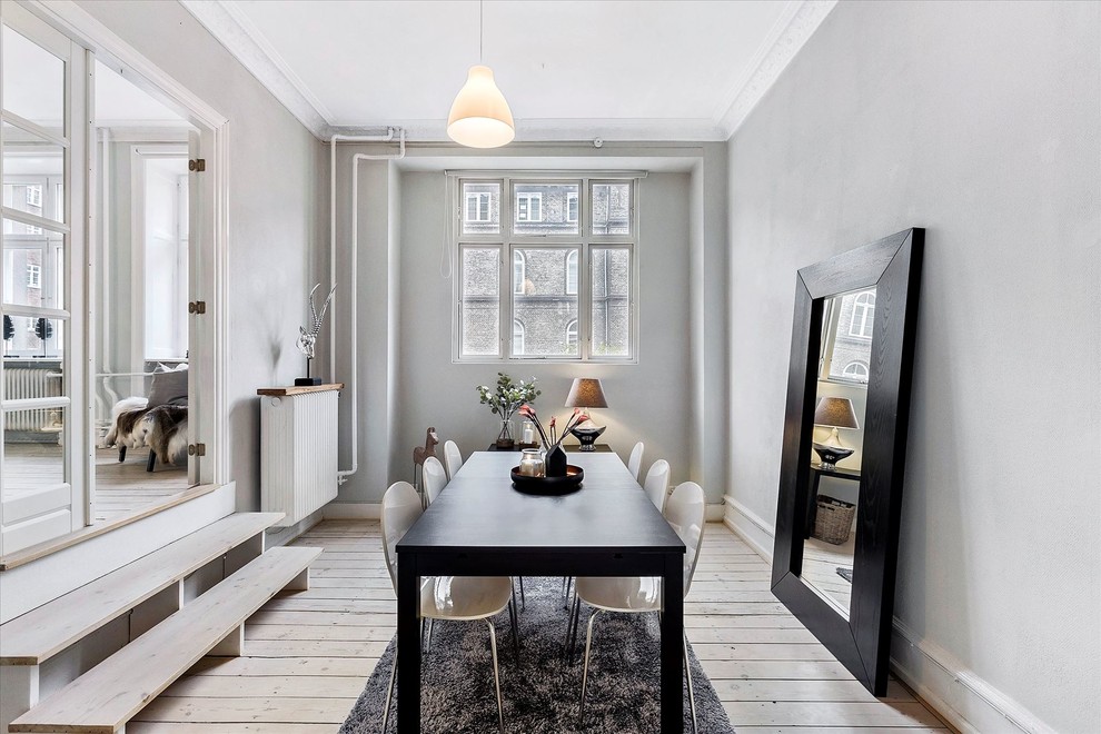 Inspiration for a scandinavian dining room in Copenhagen with grey walls, light hardwood floors and beige floor.