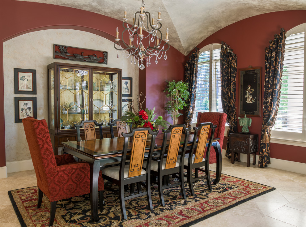 This is an example of an asian dining room in Other with red walls, no fireplace and beige floor.
