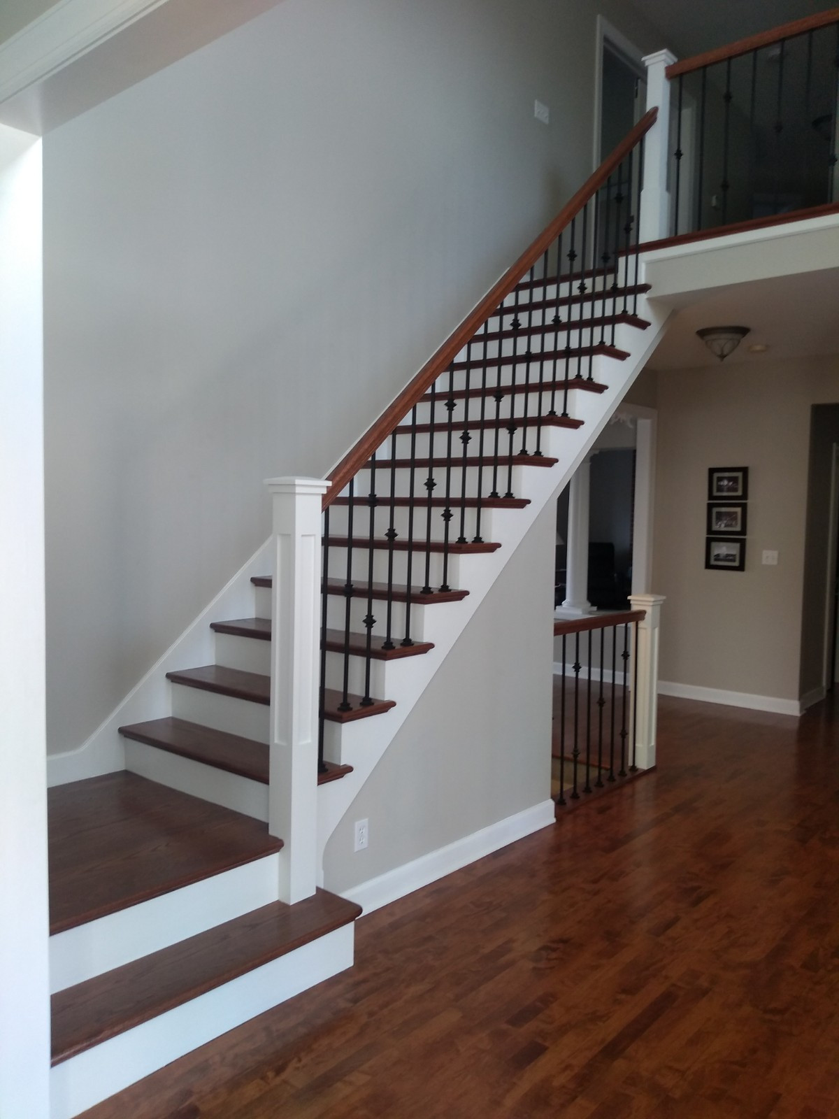 White newels with oak rails and iron balusters