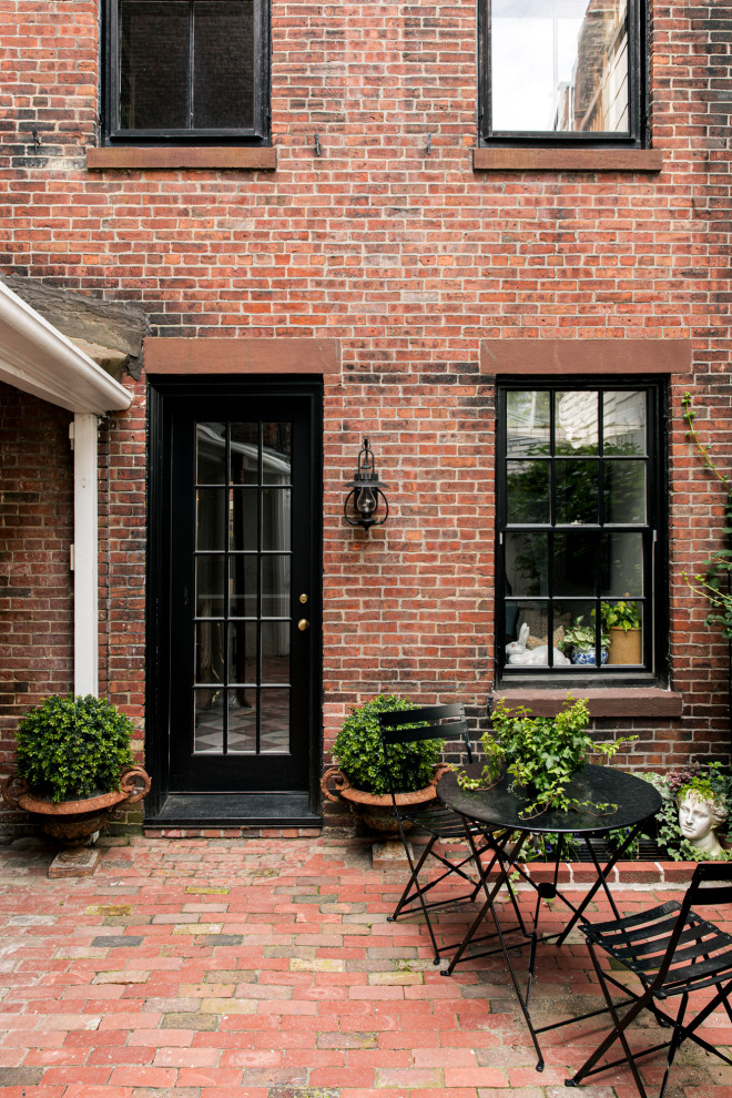 Mid-sized eclectic brick townhouse exterior in Boston with four or more storeys.