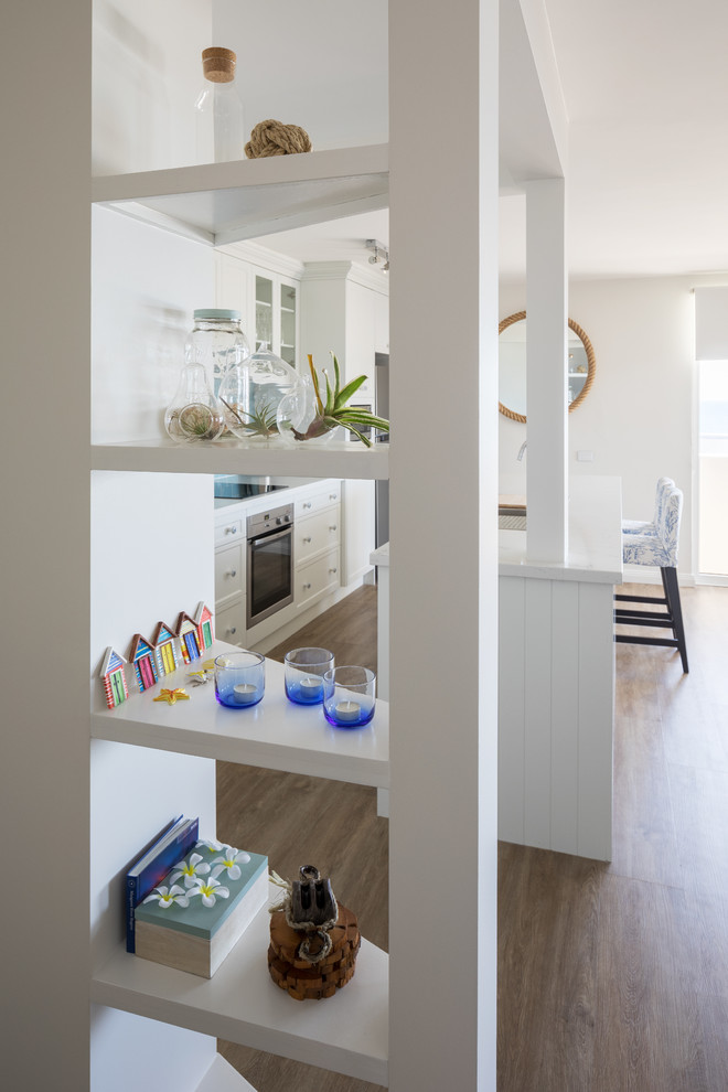Inspiration for a beach style galley kitchen in Perth with shaker cabinets, white cabinets, quartz benchtops and with island.