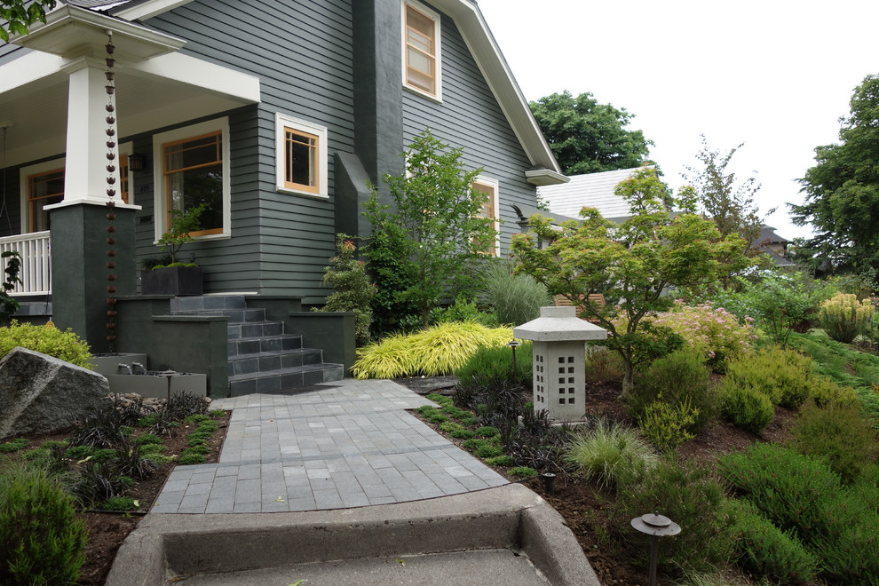 This is an example of a large industrial sloped shaded formal garden for summer in Portland with concrete pavers.