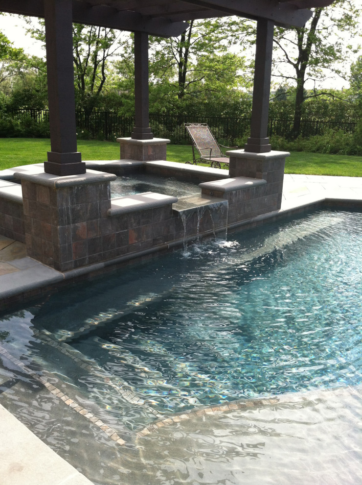 Inspiration for a transitional backyard stone and rectangular hot tub remodel in Chicago