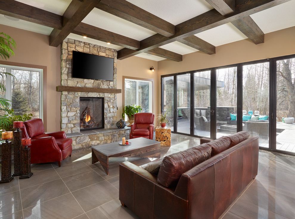 Inspiration for a large transitional formal open concept living room in Edmonton with brown walls, porcelain floors, a standard fireplace, a stone fireplace surround and a wall-mounted tv.