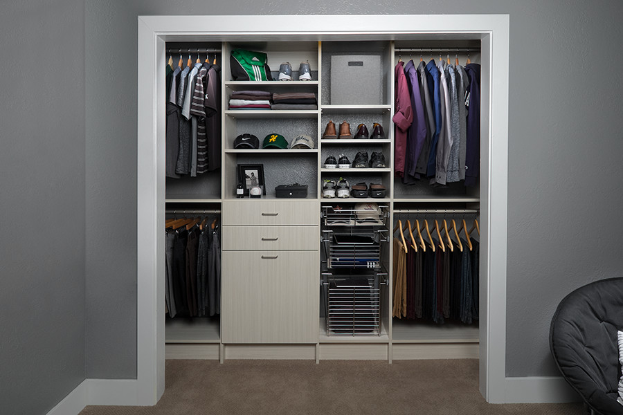 Design ideas for a small modern men's built-in wardrobe in Other with flat-panel cabinets and grey cabinets.