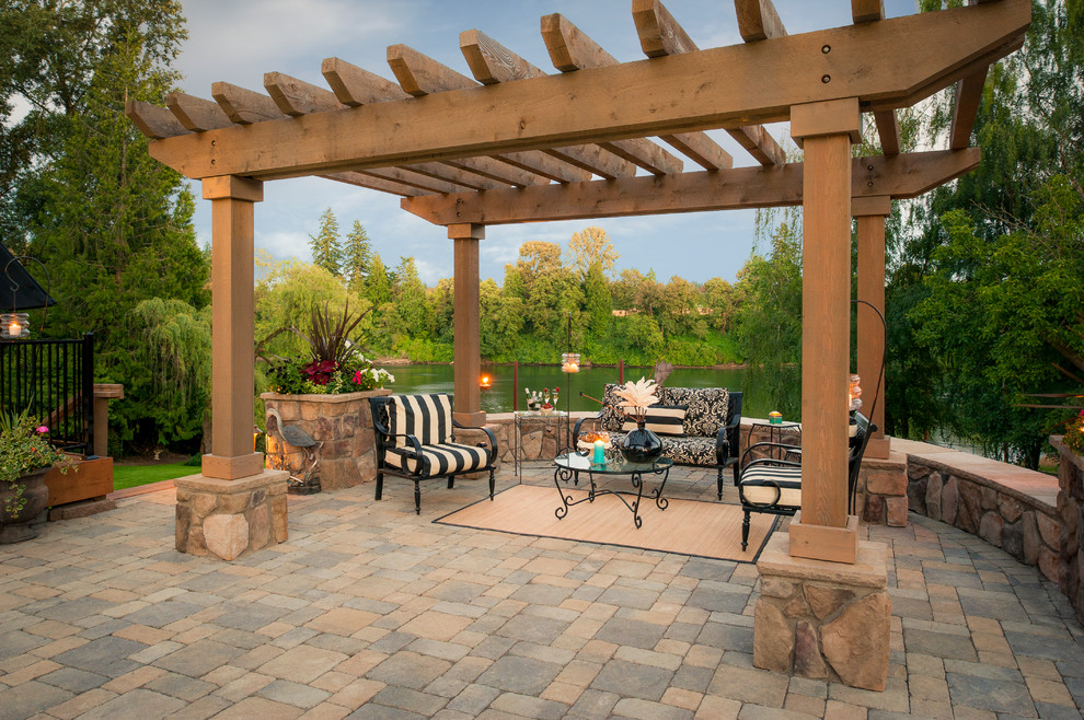 Photo of a traditional patio in Portland with concrete pavers and a pergola.