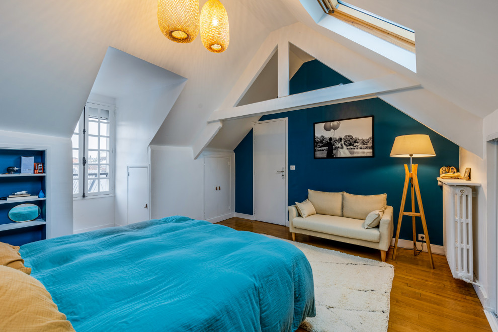 Inspiration for a large contemporary master bedroom in Paris with blue walls, light hardwood floors, brown floor and exposed beam.