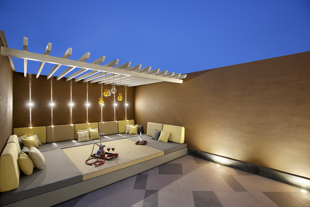Mid-sized contemporary rooftop and rooftop deck in Ahmedabad with a pergola.