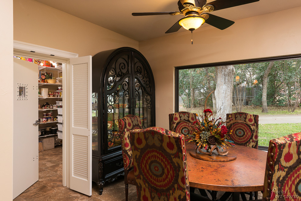 This is an example of a mid-sized traditional dining room in Dallas with travertine floors.