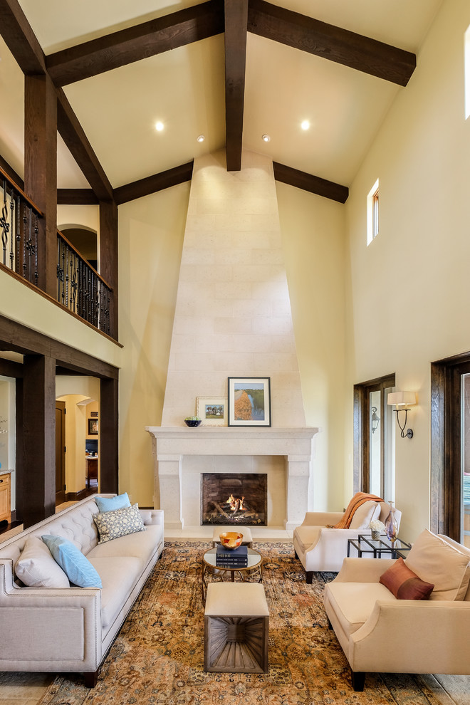 Inspiration for a mid-sized mediterranean formal living room in Sacramento with yellow walls, a standard fireplace, a stone fireplace surround, no tv and beige floor.
