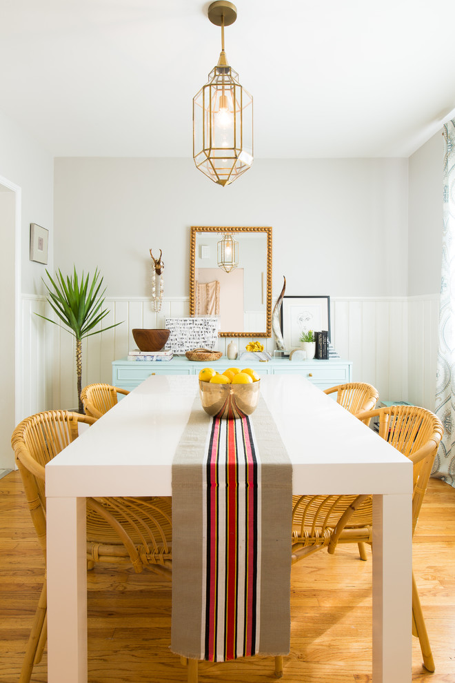 Inspiration for a beach style separate dining room in Los Angeles with grey walls, medium hardwood floors and orange floor.