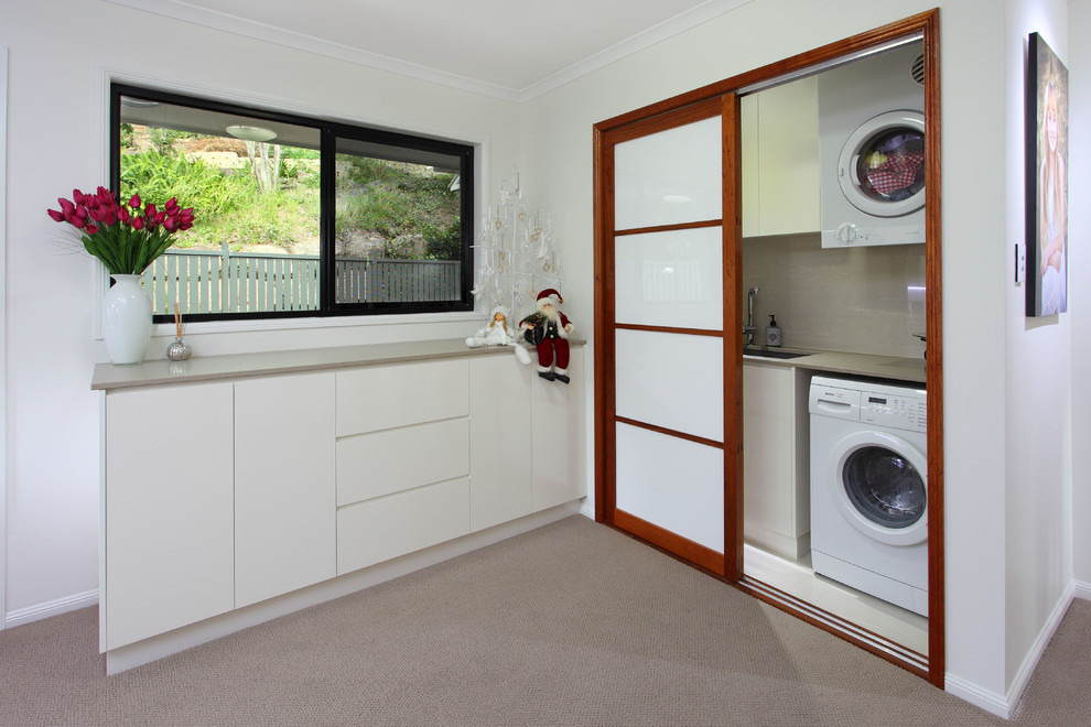 Inspiration for a small asian single-wall laundry cupboard in Brisbane with an undermount sink, flat-panel cabinets, grey cabinets, quartz benchtops, grey walls, porcelain floors, an integrated washer and dryer, white floor and grey benchtop.