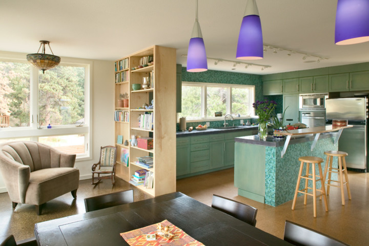 This is an example of a small contemporary l-shaped open plan kitchen in Denver with recessed-panel cabinets, green cabinets, blue splashback, glass tile splashback, stainless steel appliances, cork floors and with island.