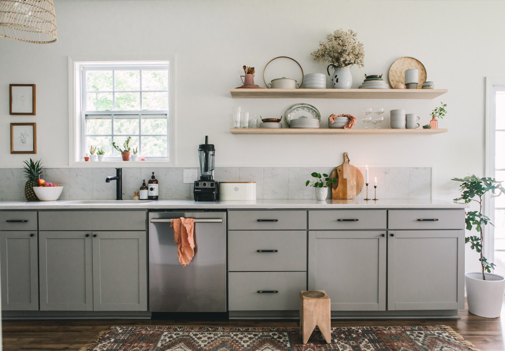 Inspiration for a mid-sized scandinavian eat-in kitchen in Raleigh with a single-bowl sink, shaker cabinets, grey cabinets, quartz benchtops, grey splashback, ceramic splashback, stainless steel appliances, laminate floors, no island, brown floor and white benchtop.