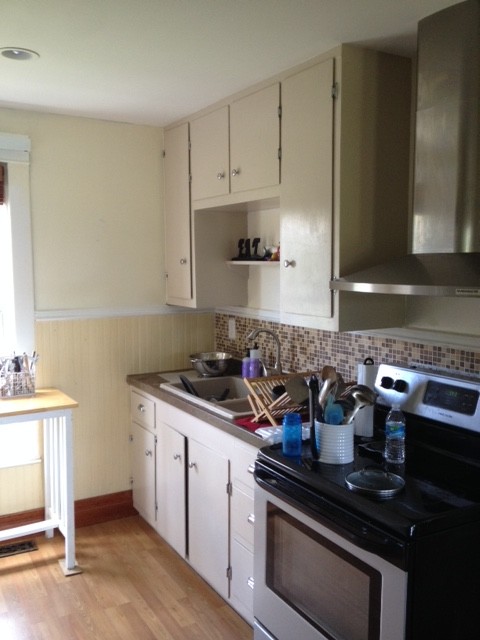 Eat-in kitchen - large light wood floor eat-in kitchen idea with recessed-panel cabinets, white cabinets, white backsplash, white appliances and an island